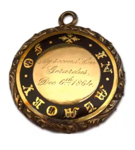 Round gold and black enamel locket. Inscribed on inner gold disk with "My second son Gerardus, Dec. 6th 1864." Inscription surrounded by outer enamelled circle by engraved inscription: "In memory of."