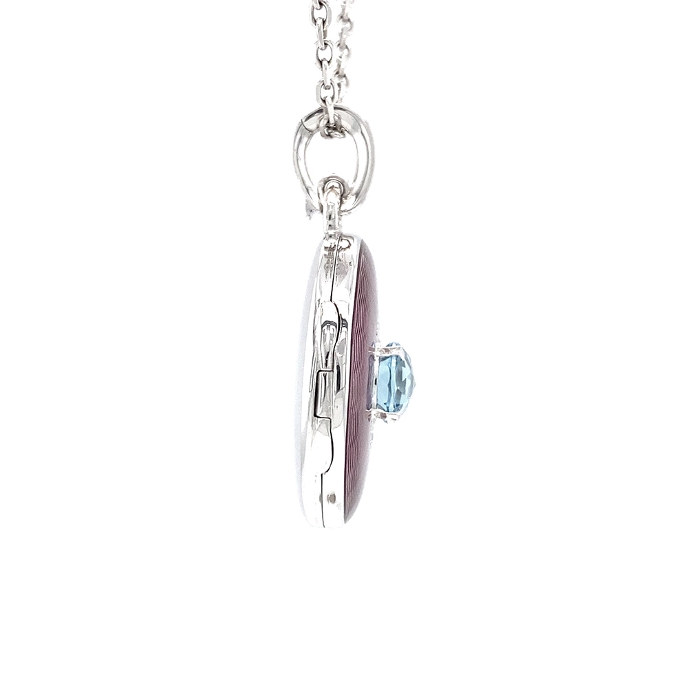 Oval pendant in white gold, with pink colour, decorated with diamonds and a blue gemstone