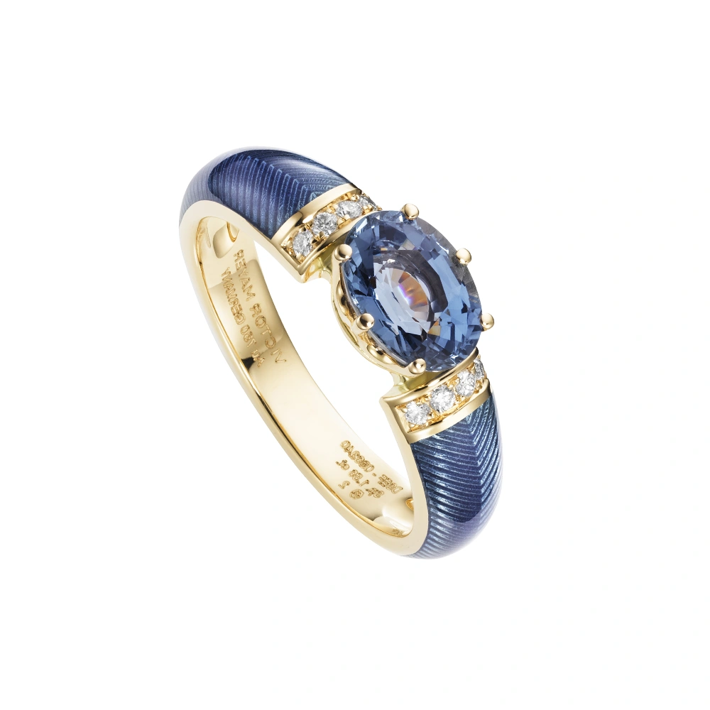Golden ring with a oval blue stone and two rows of small diamonds next to it. The ring shoulders are coloured middle blue.