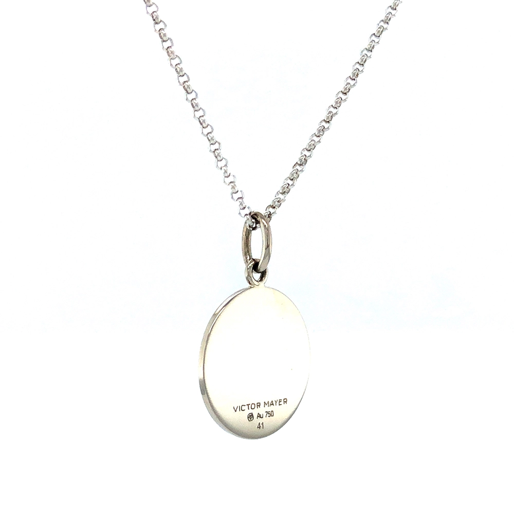 Small round pendant made of white gold, about the size of a small coin. The front shimmers in electric blue translucent enamel with a fine wave pattern. At the center lies a tiny hexagonal gold insert shaped as a star with microscopic relief details.