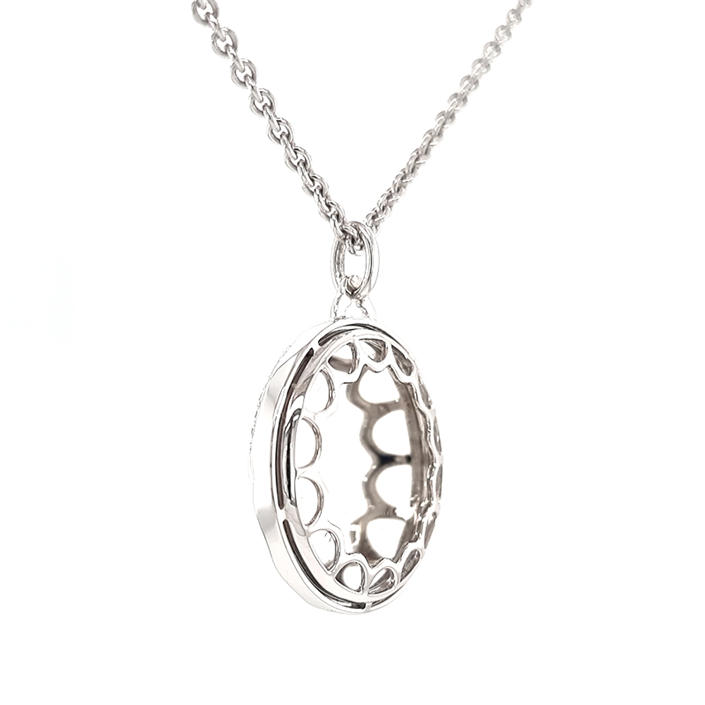 A round pendant on a chain. It is made of white gold and about the size of a large coin. The surface shines in a rich golden-amber colour with a wavy pattern. Across it runs a large flower shape made of many small diamonds. The pendant hangs from a fine chain.