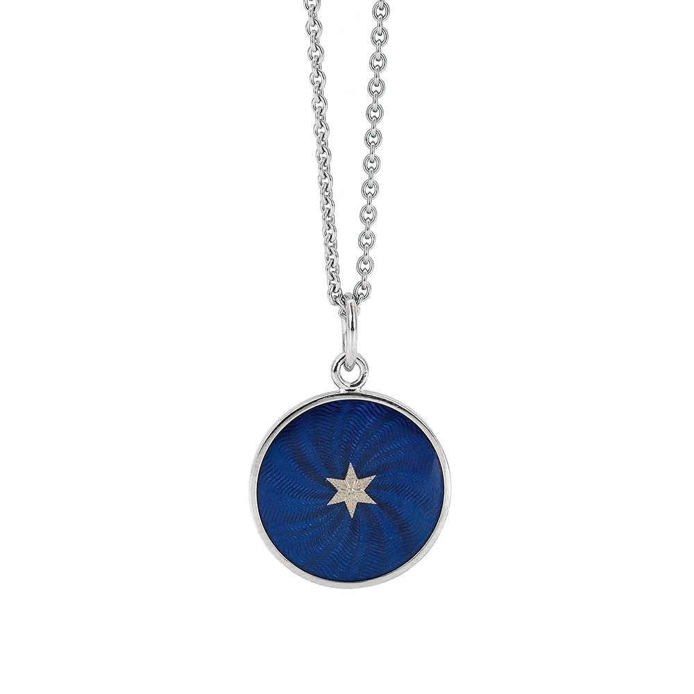 Small round pendant made of white gold, about the size of a small coin. The front shimmers in electric blue translucent enamel with a fine wave pattern. At the center lies a tiny hexagonal gold insert shaped as a star with microscopic relief details.