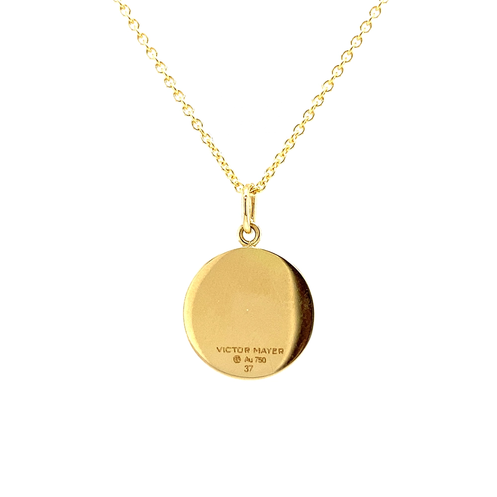 Small round pendant made of yellow gold, about the size of a small coin. The front shimmers in turquoise translucent enamel with a fine wave pattern. At the center lies a tiny hexagonal gold insert shaped as a star with microscopic relief details.