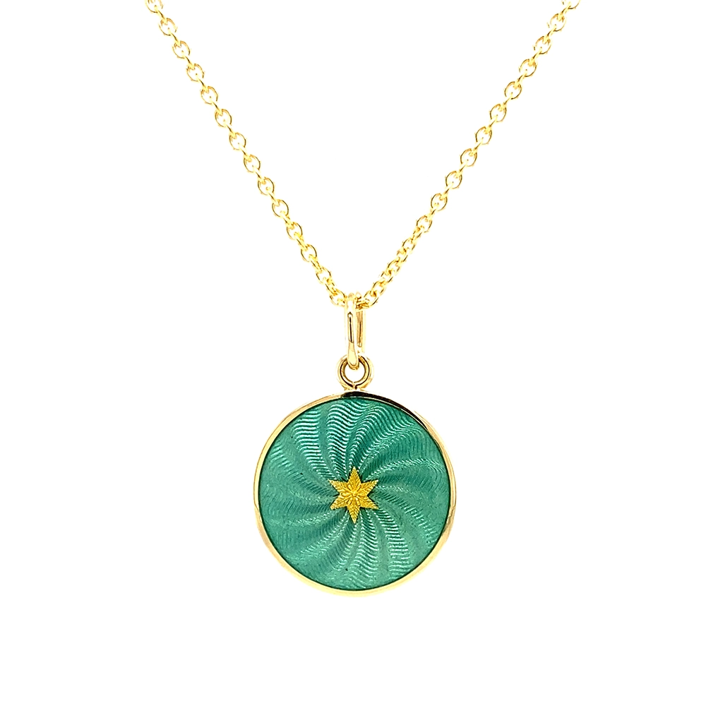 Small round pendant made of yellow gold, about the size of a small coin. The front shimmers in turquoise translucent enamel with a fine wave pattern. At the center lies a tiny hexagonal gold insert shaped as a star with microscopic relief details.