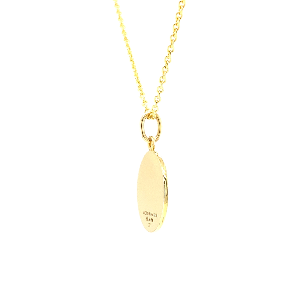 Small round pendant made of yellow gold, about the size of a small coin. The front shimmers in turquoise translucent enamel with a fine wave pattern. At the center lies a tiny hexagonal gold insert shaped as a star with microscopic relief details.