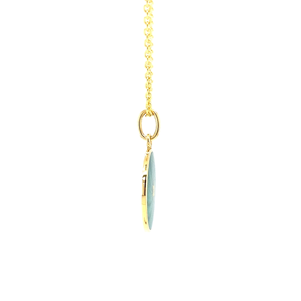 Small round pendant made of yellow gold, about the size of a small coin. The front shimmers in turquoise translucent enamel with a fine wave pattern. At the center lies a tiny hexagonal gold insert shaped as a star with microscopic relief details.
