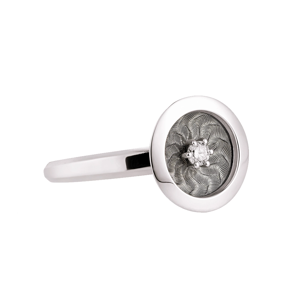 Ring in white gold with a round ring head. The ring head is concave and covered with translucent tahiti-grey vitreous enamel, beneath which a fine windmill guilloché pattern is visible. A single small diamond is set at the centre of the enamel surface as a subtle focal point. The design appears calm, geometric, and balanced.