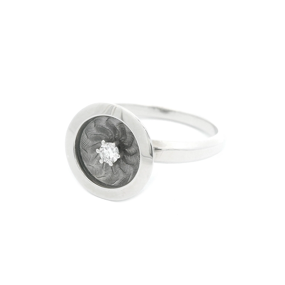 Ring in white gold with a round ring head. The ring head is concave and covered with translucent tahiti-grey vitreous enamel, beneath which a fine windmill guilloché pattern is visible. A single small diamond is set at the centre of the enamel surface as a subtle focal point. The design appears calm, geometric, and balanced.