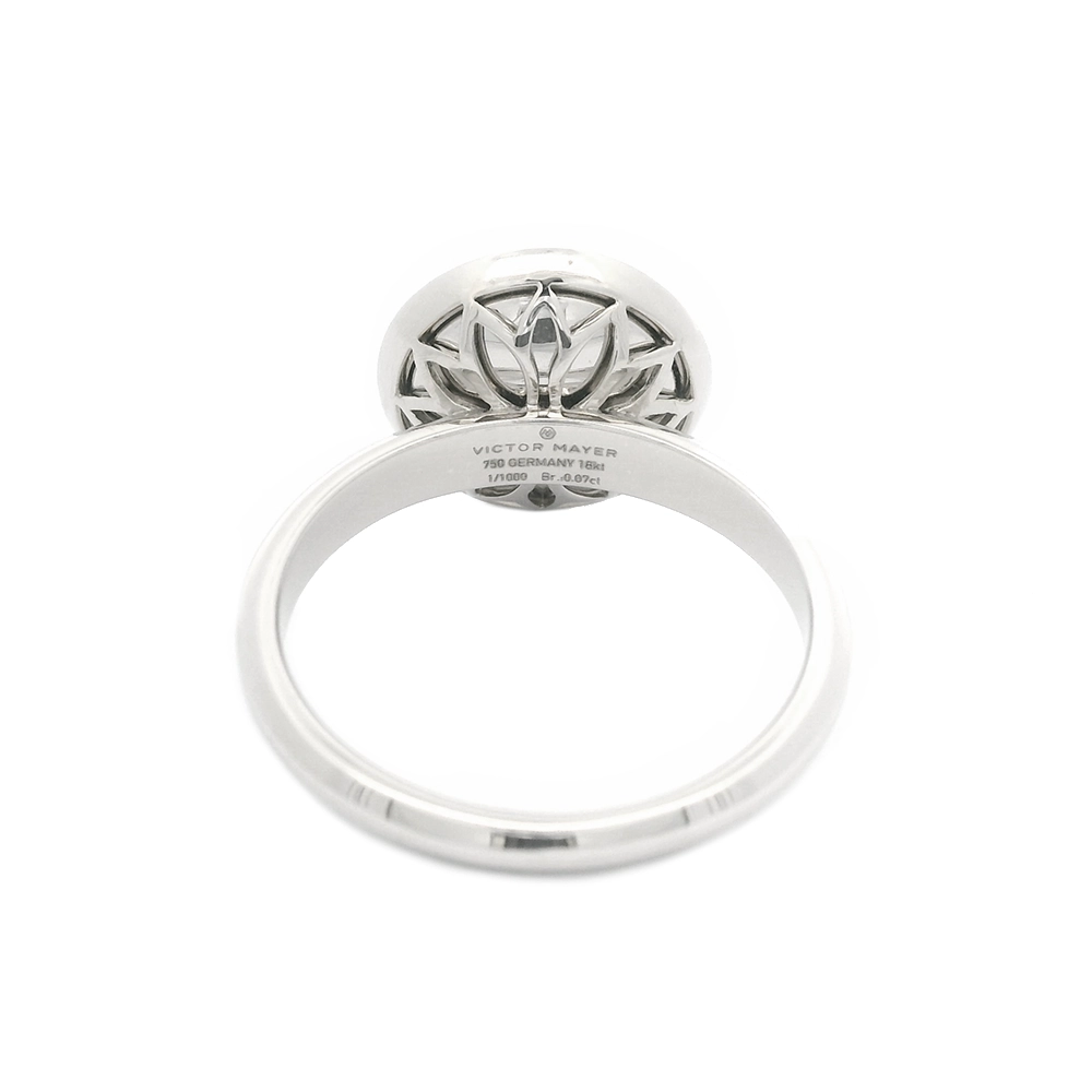 Ring in white gold with a round ring head. The ring head is concave and covered with translucent tahiti-grey vitreous enamel, beneath which a fine windmill guilloché pattern is visible. A single small diamond is set at the centre of the enamel surface as a subtle focal point. The design appears calm, geometric, and balanced.