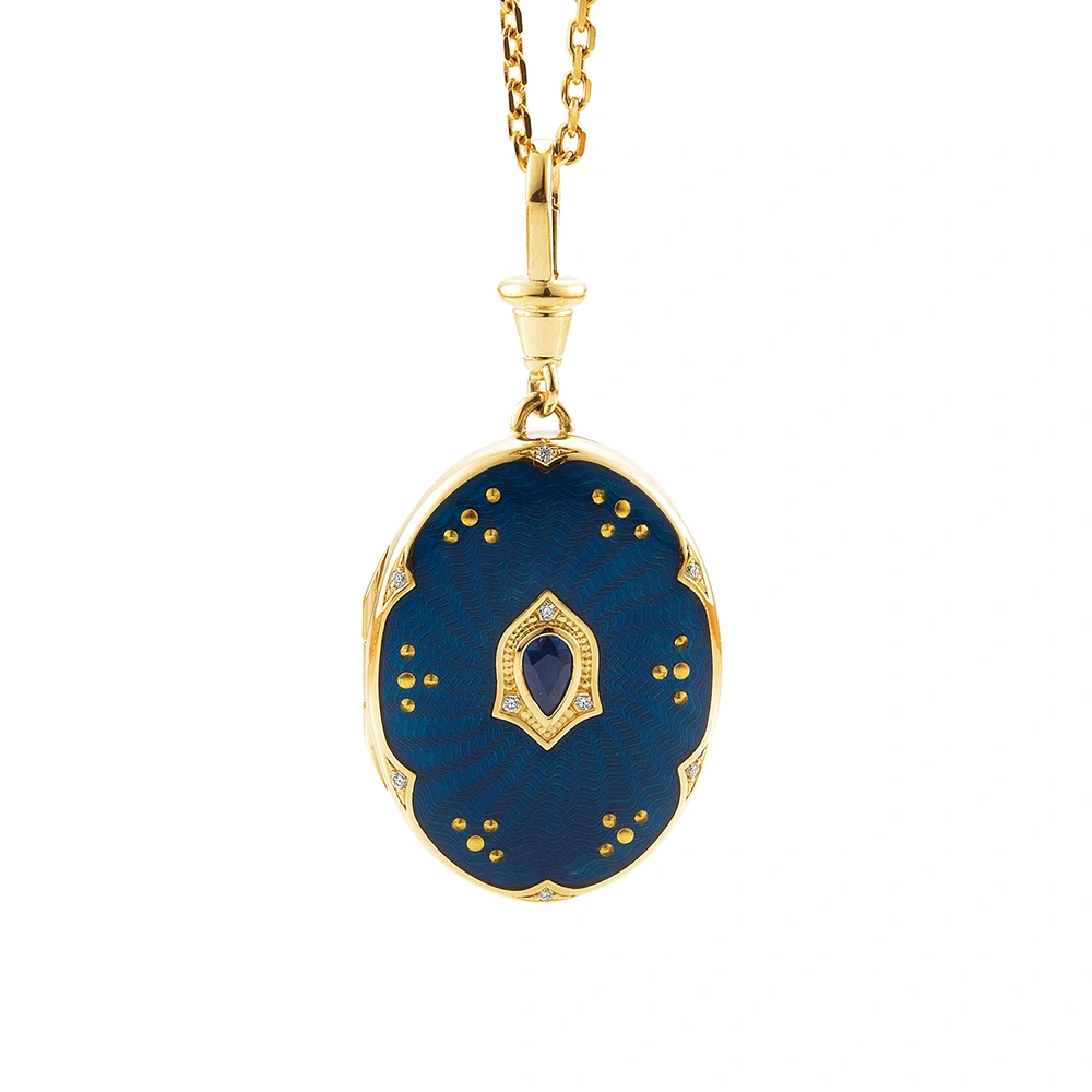 Ovaler Medaillon-Anhänger aus Gelbgold, blau lackiert mit zahlreichen kleinen Goldpunkten und mit einem tropfenförmigen blauen Edelstein in der Mitte.
