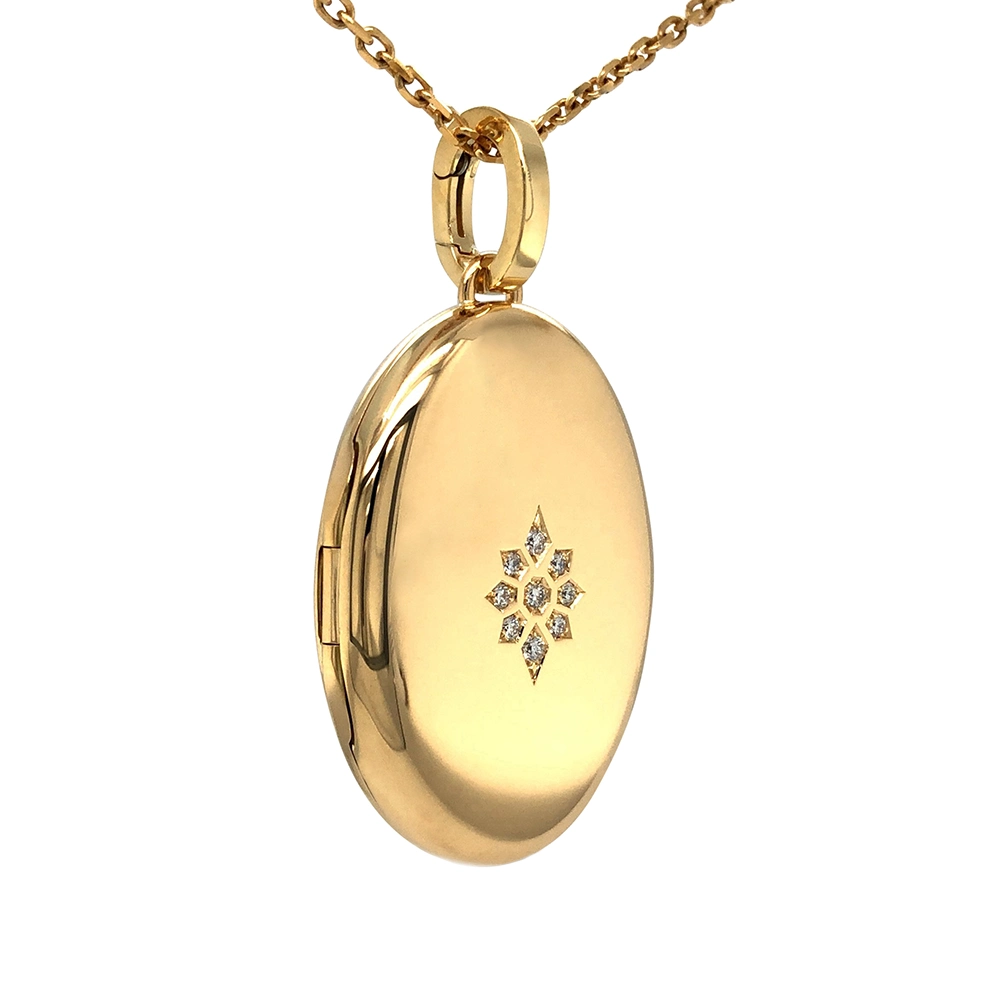Oval locket pendant in yellow gold with brilliant-cut diamonds set in a star shape.