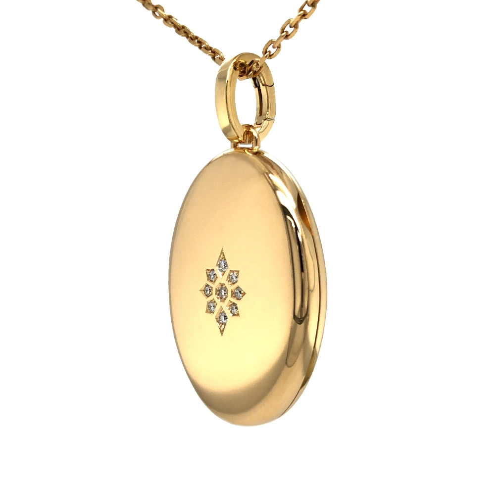Oval locket pendant in yellow gold with brilliant-cut diamonds set in a star shape.