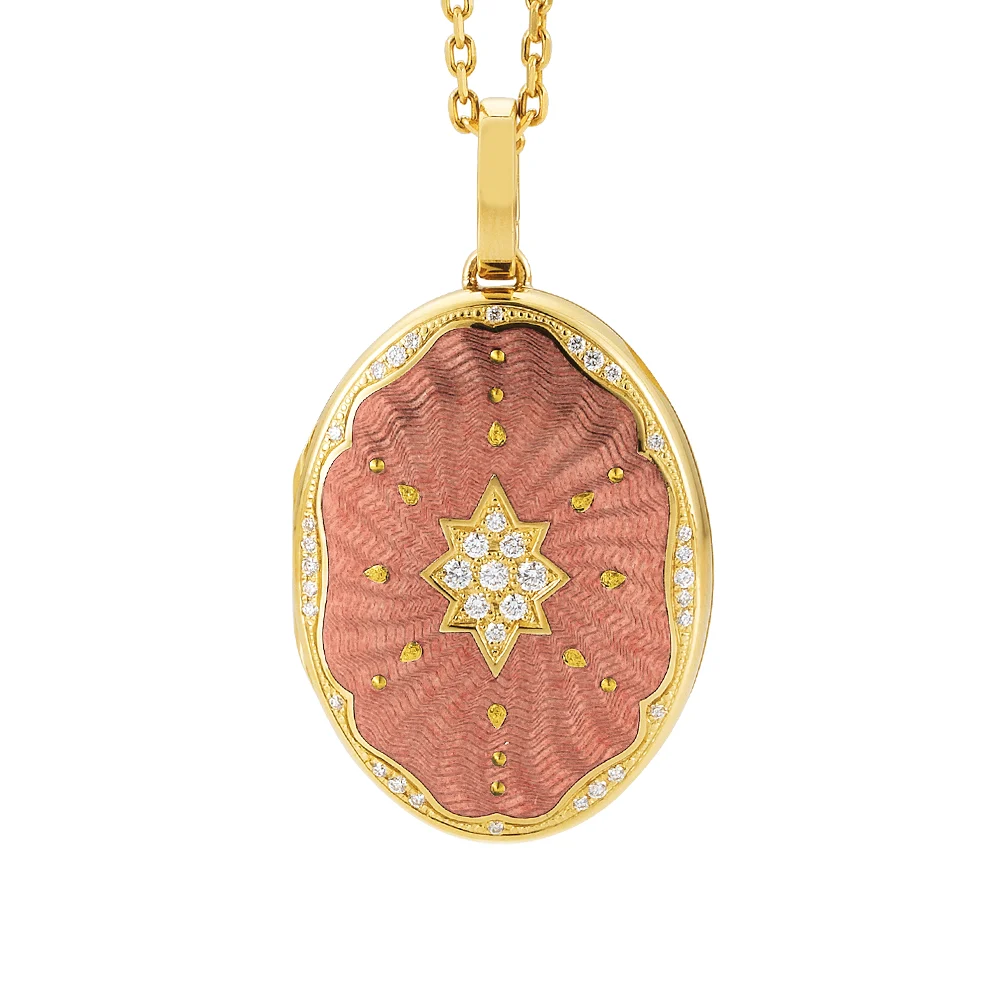 Ovaler Medaillon-Anhänger aus Gelbgold, rosa lackiert mit einer vielzahl kleiner goldener Punkte und mit einem Stern aus Brillanten in der Mitte.