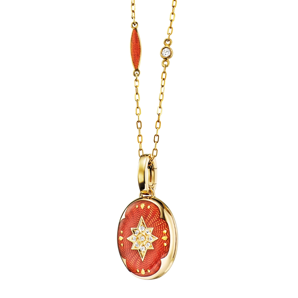 Oval locket pendant in yellow gold, lacquered light red with a multitude of small golden dots and a star made of diamonds in the centre,