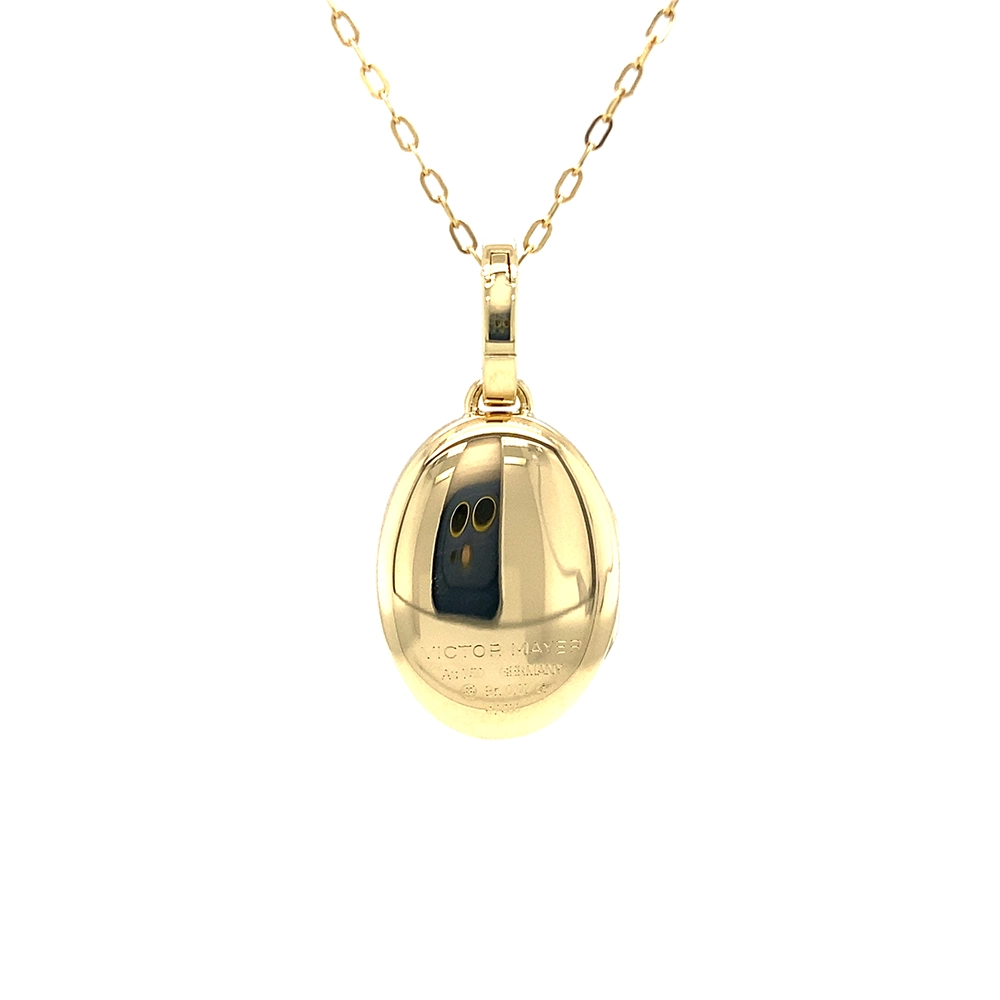Oval locket pendant in yellow gold, lacquered light red with a multitude of small golden dots and a star made of diamonds in the centre,