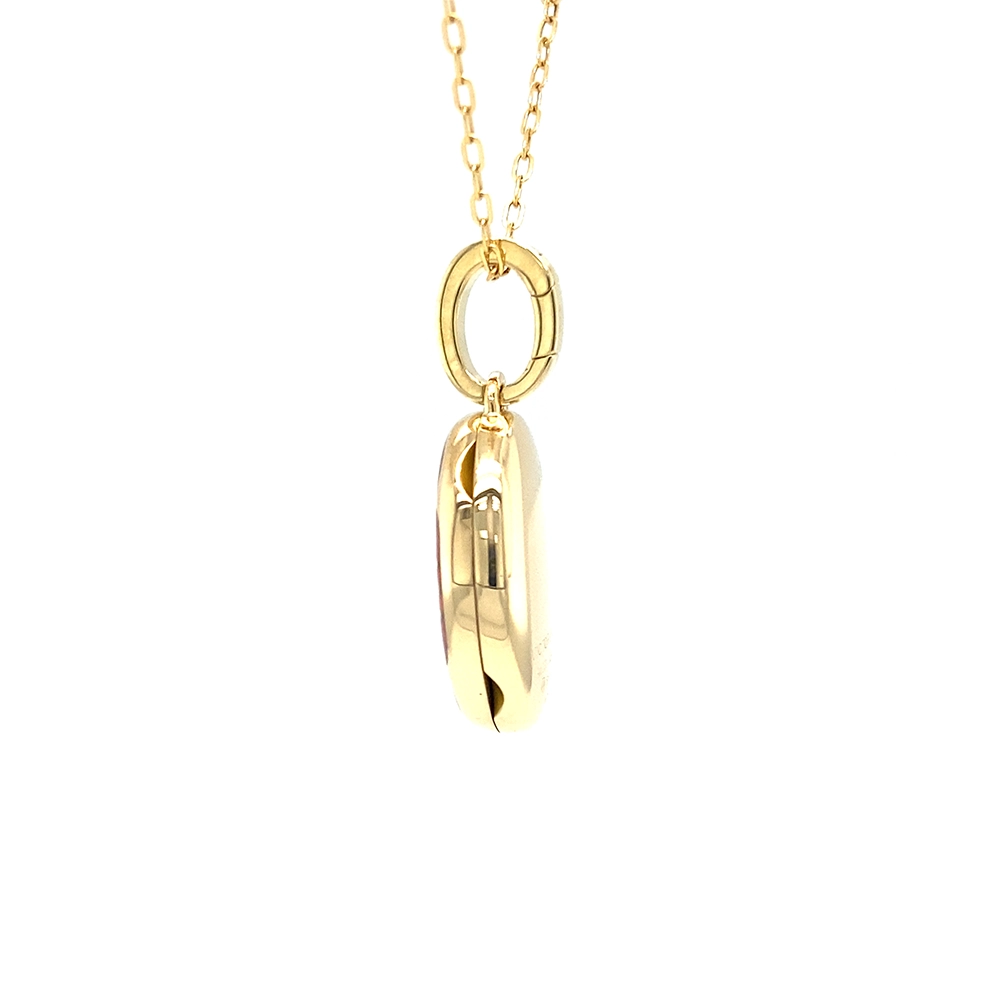 Oval locket pendant in yellow gold, lacquered light red with a multitude of small golden dots and a star made of diamonds in the centre,