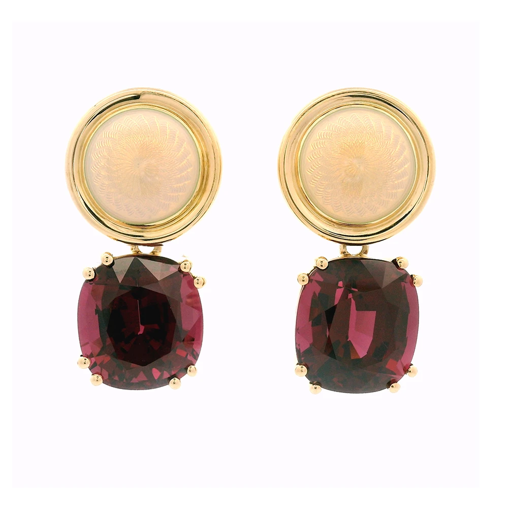 Pair of yellow-gold earrings with red cushion-cut rhodolites in four-claw settings and round white enamel boutons with gold rims.